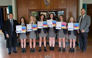 Royal School Armagh pupils celebrating Cyber Explorers Cup 2026 success with Mr Forrest and Headmaster Mr Montgomery