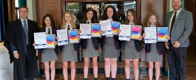 Royal School Armagh pupils celebrating Cyber Explorers Cup 2026 success with Mr Forrest and Headmaster Mr Montgomery